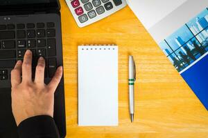 Hand typing computer on table office blank note fill text. photo