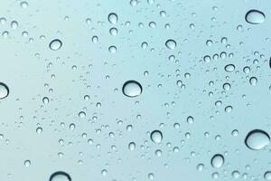 Water drop on sky glass mirror background. photo