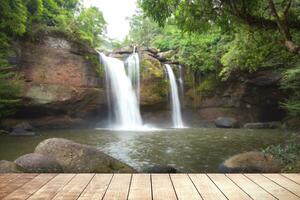Wooden table with environmental in water fall  forest. photo