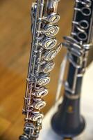 A part of the classical wind instrument flute with brass details. Close up of trumpet finger buttons valves photo