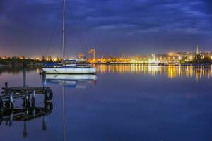 amazing view from a pier to yacht and city lights water reflection photo