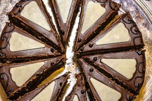 Delicious chocolate Sacher cake, cutting to the pieces. Top view photo