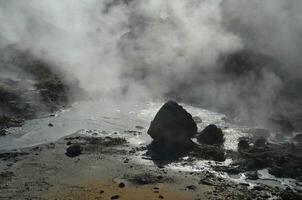 Natural Hot Spring with Steam Rising from it Iceland photo