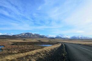 Road Trip with Snow Covered Mountains and Stunning Scenery photo