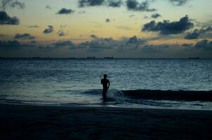 Young Man Running into the Ocean Waters photo