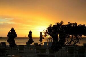 Beach Resort Silhouetted at Sunset in Aruba photo