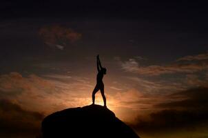 Woman Reaching Up to the Sky at Sunrise photo