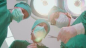 Blurred focus of specialist surgeons and assistant practitioners doctor team discuss and analyze for surgery operations on critically ill patients in hospital's ICU, and paramedic treatment. video