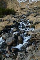 Waterfall Down the Side of a Mountain as the Snow Melts photo