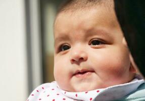 Close Up Shot of Cute Asian Pakistani 4 Months Old Baby Boy, Who is Enjoying at Home Garden at Luton City of England UK. Image Was Captured on July 23rd, 2023 photo