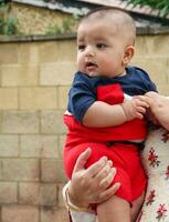 cerca arriba Disparo de linda asiático pakistaní 4 4 meses antiguo bebé chico, quien es disfrutando a hogar jardín a lutón ciudad de Inglaterra Reino Unido. imagen estaba capturado en julio 23, 2023 foto