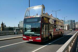 Gorgeous Low Angle view of Bus Service and British Traffic at London Bridge Which is Most Famous and Historical Bridge over River Thames at Central London City of England UK. June 4th, 2023 photo