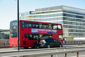 Gorgeous Low Angle view of Bus Service and British Traffic at London Bridge Which is Most Famous and Historical Bridge over River Thames at Central London City of England UK. June 4th, 2023 photo