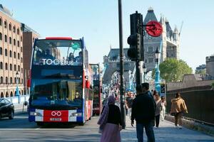 Gorgeous Low Angle view of Bus Service and British Traffic at London Bridge Which is Most Famous and Historical Bridge over River Thames at Central London City of England UK. June 4th, 2023 photo