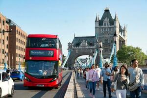 Gorgeous Low Angle view of Bus Service and British Traffic at London Bridge Which is Most Famous and Historical Bridge over River Thames at Central London City of England UK. June 4th, 2023 photo