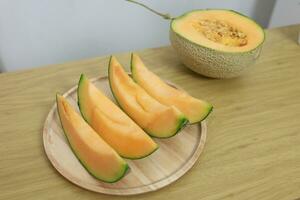 Fruits for healthcare Green Melon wooden table honey melon or cantaloupe photo