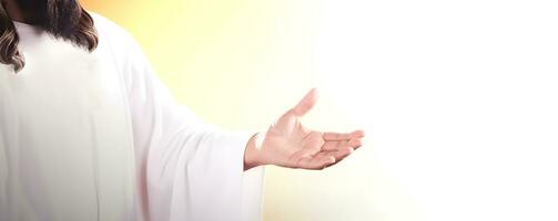 Jesus Christ reaching out his hand against bright background photo