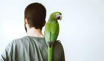 Beautiful green Monk parrot sitting on shoulder of man. photo