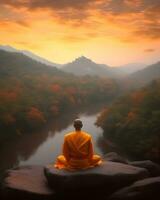 Buddhist monk in meditation on mountaintop at beautiful sunset or sunrise photo