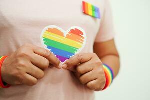 Asian woman with rainbow flag, LGBT symbol rights and gender equality, LGBT Pride Month in June. photo