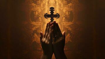 Crucifix resting on brown surface held by female hands. silhouette concept photo