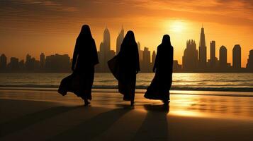 Three women in traditional clothing standing at Dubai s beach. silhouette concept photo