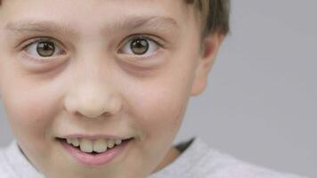a close up of a smiley young boy with big eyes video