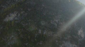 the sun shines through the clouds above a mountain video