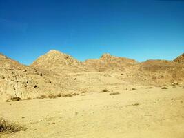 Desert land with mountains and sea photo