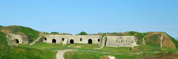 Medieval ruins of bank of fortress photo