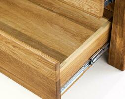 Opened wooden drawer with a slider close view photo, wooden eco furniture elements background. Solid wood furniture details photo