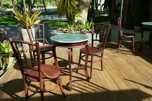 Restaurant wooden chairs against morning sunlight photo