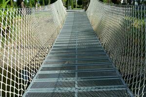 Steel rope bridges are used to cross wells for resort and accommodation tourism photo