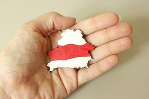 Silhouette of Country Belarus, White red white National flag lying in Hand. Symbol of protest, Color image. Love, Peace, Freedom, Independence. Image for Book, Booklet, Brochure, Poster, Banner, Print photo