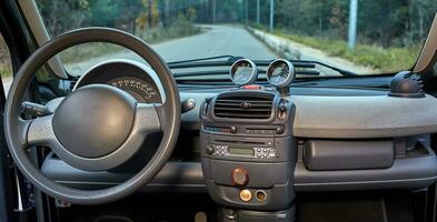 Car steering wheel and interior background, modern city car elements close view. Car inside interior photo