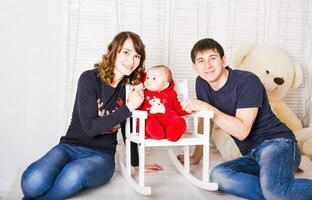 Young, happy family in a room interior photo