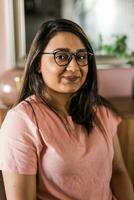 Head shot portrait smart confident smiling millennial indian woman. Attractive young hindu teenager student girl freelancer looking at camera, posing for photo. photo