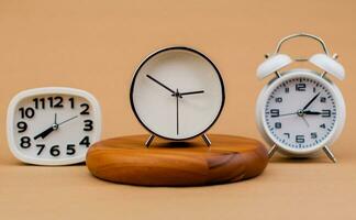 Alarm clock placed on a wooden stand, time work concept the value of limited time Appointments and punctuality at work photo