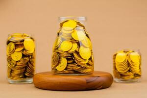 Saving gold in a glass jar Real estate and valuables Gold coins World gold market Gold stocks Invest in gold photo