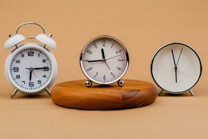 Alarm clock placed on a wooden stand, time work concept the value of limited time Appointments and punctuality at work photo