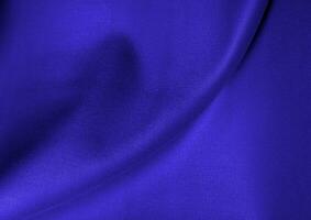 Deep blue glossy cloth texture background. Natural textile material photo, pattern cover photo