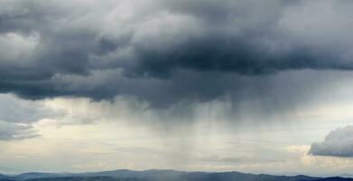 Thunderstorm coming and clouds raining photo