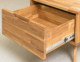Opened drawer close view photo, wooden furniture elements background. Furniture details photo