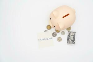 concept of emergency savings fund. A piggy bank with dollar and coins. piggy bank for saving emergency money.Saving for emergency concept. isolated background. photo