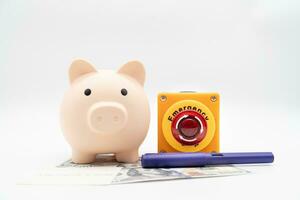 Concept of emergency savings fund. A piggy bank with dollar and stop button. money with piggy bank for saving emergency money. photo