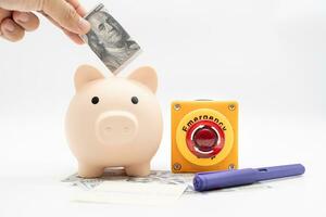 Concept of emergency savings fund. A piggy bank with dollar and stop button. money with piggy bank for saving emergency money. photo