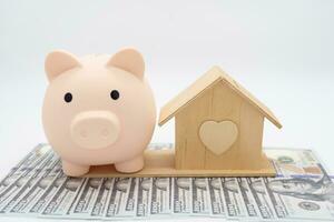 Piggy bank and house on a white background. real estate concept. concept of saving money to buy an apartment, house or other residential property. photo