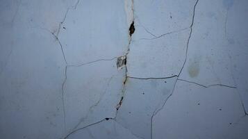 Cement wall collapse. Cracked concrete old wall. dangerous, damaged building structure. photo