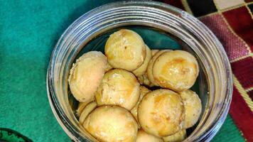 Nastar or indonesian pineapple tart cookies in glass jar photo