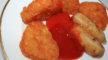 plate of delicious potatoes and baked sausage photo